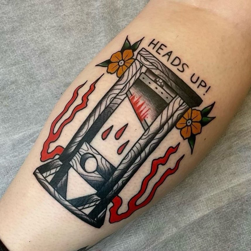 traditional-tattoo-matt10 Image of a new tattoo on a mans arm. The style of the tattoo blends realism style with an artistic flair. It is black and grey and also red colour.